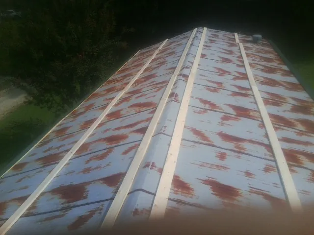 Rusted metal roof panels with new wood purlins before replacement — Storm Damage Roof Repair in Cotati by Roofing Brothers
